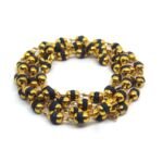 Black Tulsi Mala In Brass Golden Self Design Caps